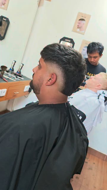Textured haircut with a carefully blended fade, by Danz