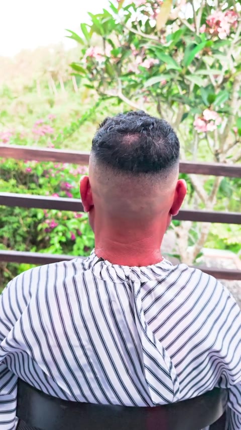 Back view of a short haircut with a clean fade